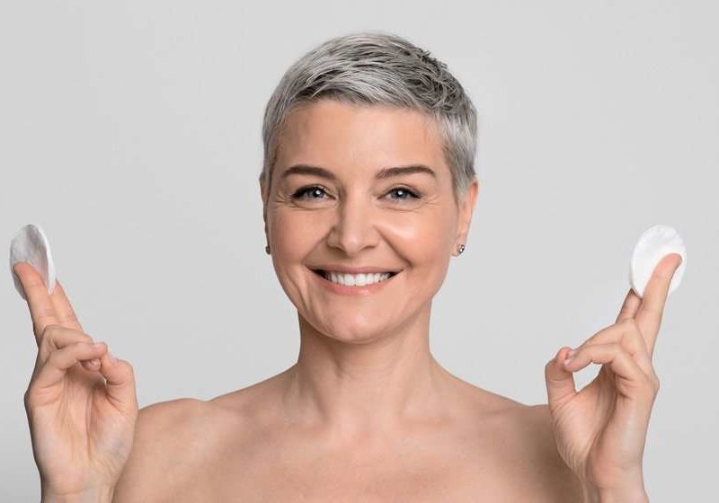 short-haired-middle-aged-woman-smiling-skin-care-concept