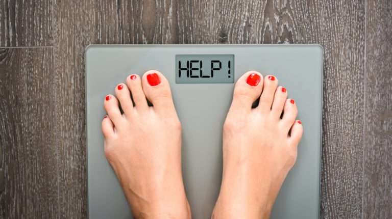 woman feet on a weight scale Finally Lose The Stubborn Weight with Hormone Optimization and Peptide Therapy feat ss