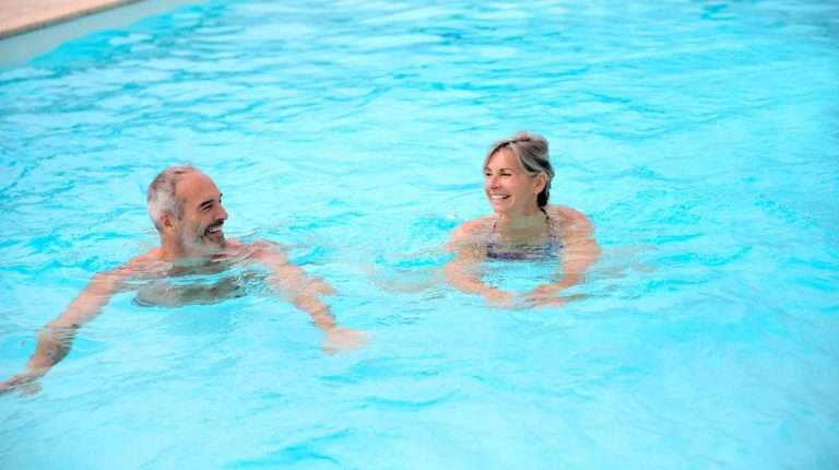 middle-aged-couple-swimming-together