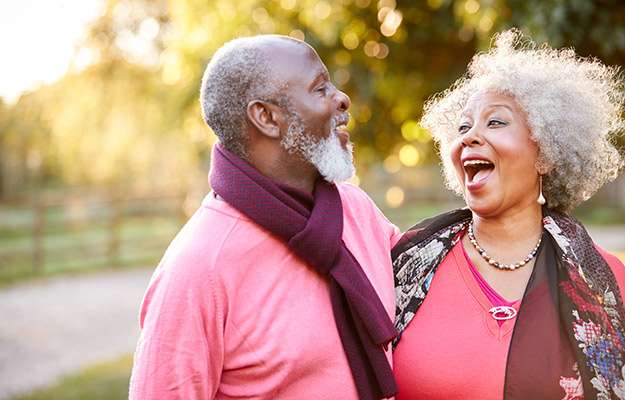 Happy black senior couple smiling with each other - SS