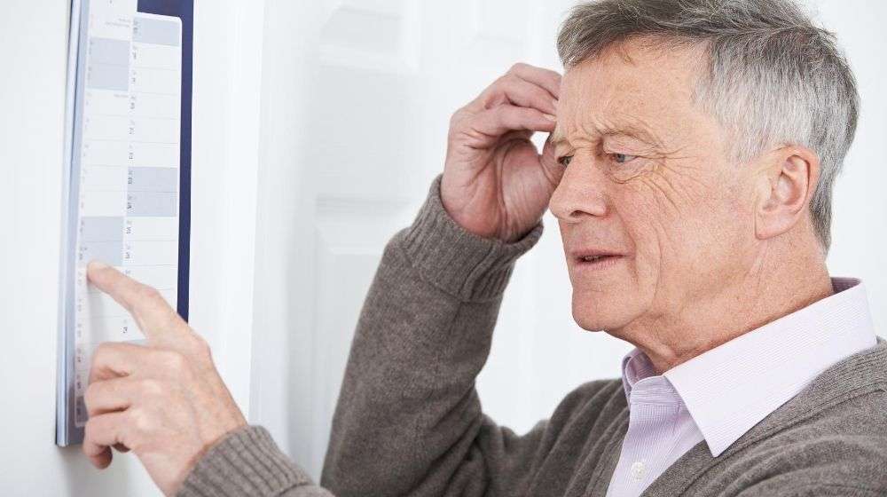 an-old-man-standing-in-front-of-the-calendar | Feature | How To Avoid Alzheimer’s and Dementia (6 Ways)