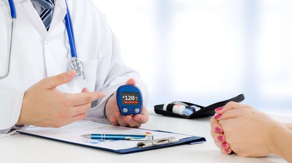 Doctor-shows-glucometer-with-glucose-level | feature | Is Diabetes an Autoimmune Disease? And What Are Possible Treatment Options?
