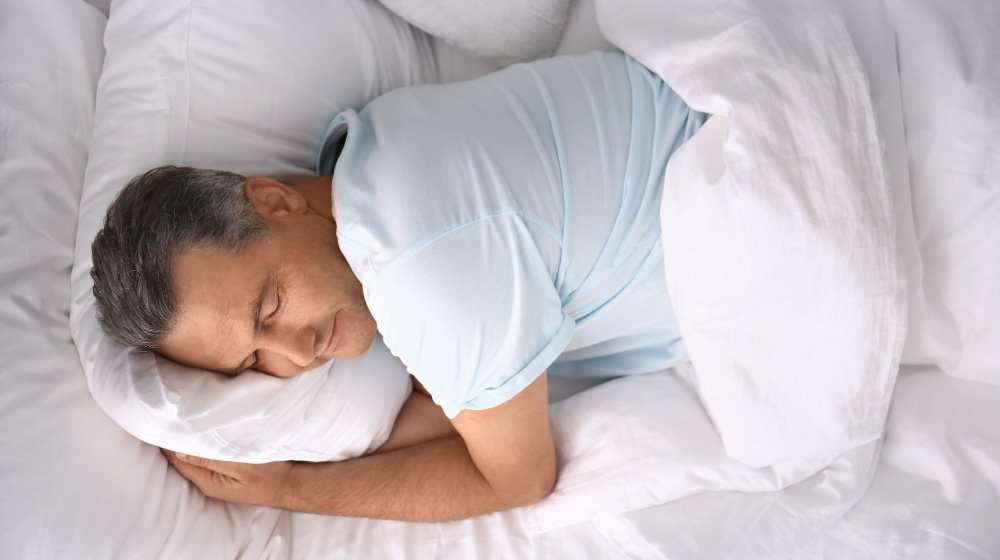 Man-sleeping-on-comfortable-pillow-in-be | feature | 4 Ways To Improve Sleep For Better Health