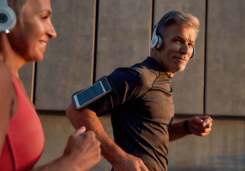 man-in-headphones-running-with-his-wife-through-the-city-street----------How-To-Increase-Focus,-Energy,-and-Performance_feature