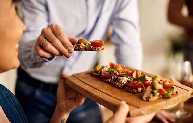 woman holding wooden board with bruschetta upon | What Is A Personalized Weight Loss Program?