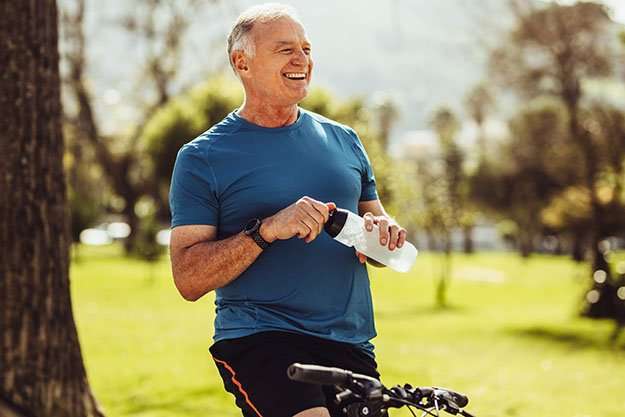 Senior-man-in-fitness-wear-drinking-water-sitting-on-his-bicycle-Protects-Against-Prostate-Issues-ss-body