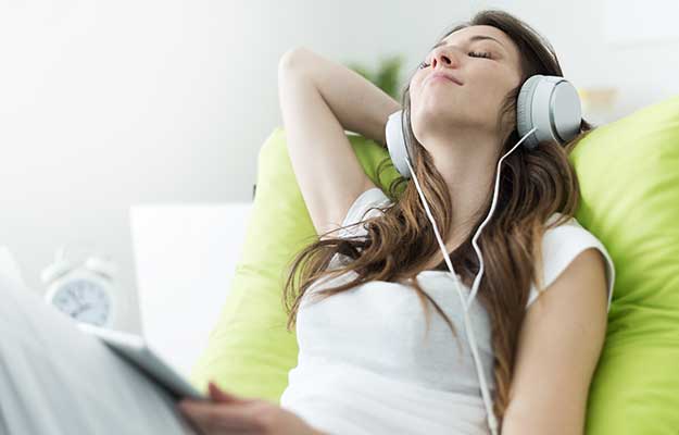 Beautiful-young-woman-with-headphones-relaxing-on-the-bed-ss-body | How To Improve Gut Health In # Ways