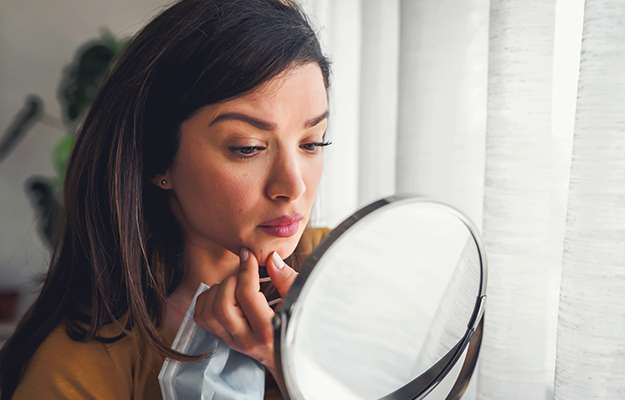 Woman-looking-herself-in-the-mirror-at-home-ss-body | # Facts & Myths About Female Testosterone Replacement Therapy