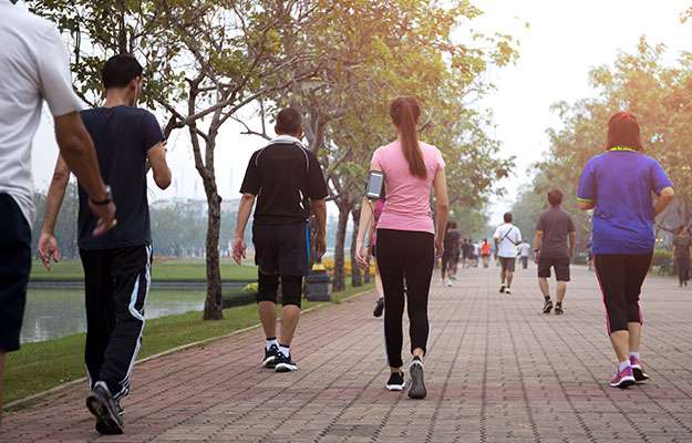 Group-of-people-exercise-walking-in-the-park-ss-body | Scientists Claim That 10,000 Steps A Day Is Not Optimal For Longevity