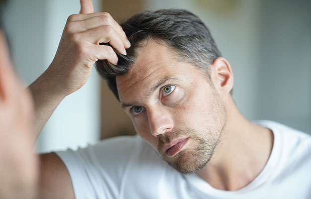 Portrait-of-a-man-worried-about-hair-loss-ss-body | Why Is There A Steady Decrease In Testosterone Levels Of Men In The US