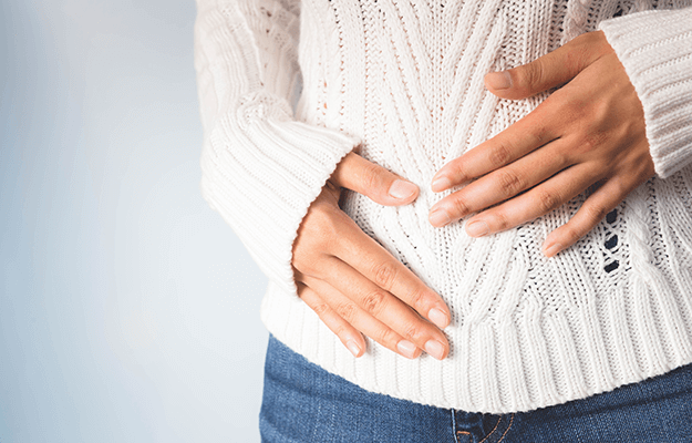 A woman with indigestion symptoms What Causes Binge Eating Disorder