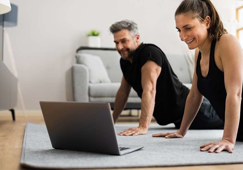 Couple-Doing-Online-Stretching-Class-Workout-And-Fitness-Exercise-How-Weekend-Workouts-Yield-Similar-Benefits-to-Daily-Workouts