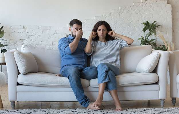 Tired-stressed-young-couple-arguing-at-home-sitting-on-sofa-together-Women-Tend-to-Avoid-Conversations-on-Sexual-Health
