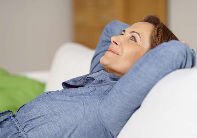 YM-Happy-middle-aged-woman-relaxing-at-home-reclining-on-a-comfortable-sofa-ss-Selank-Peptide-Benefits-Dosage-Side-Effects
