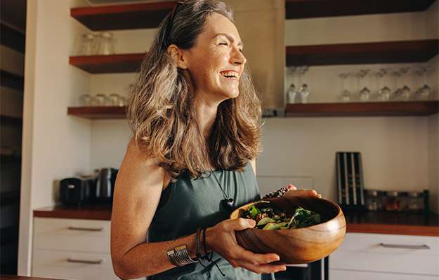 smiling woman holding salad