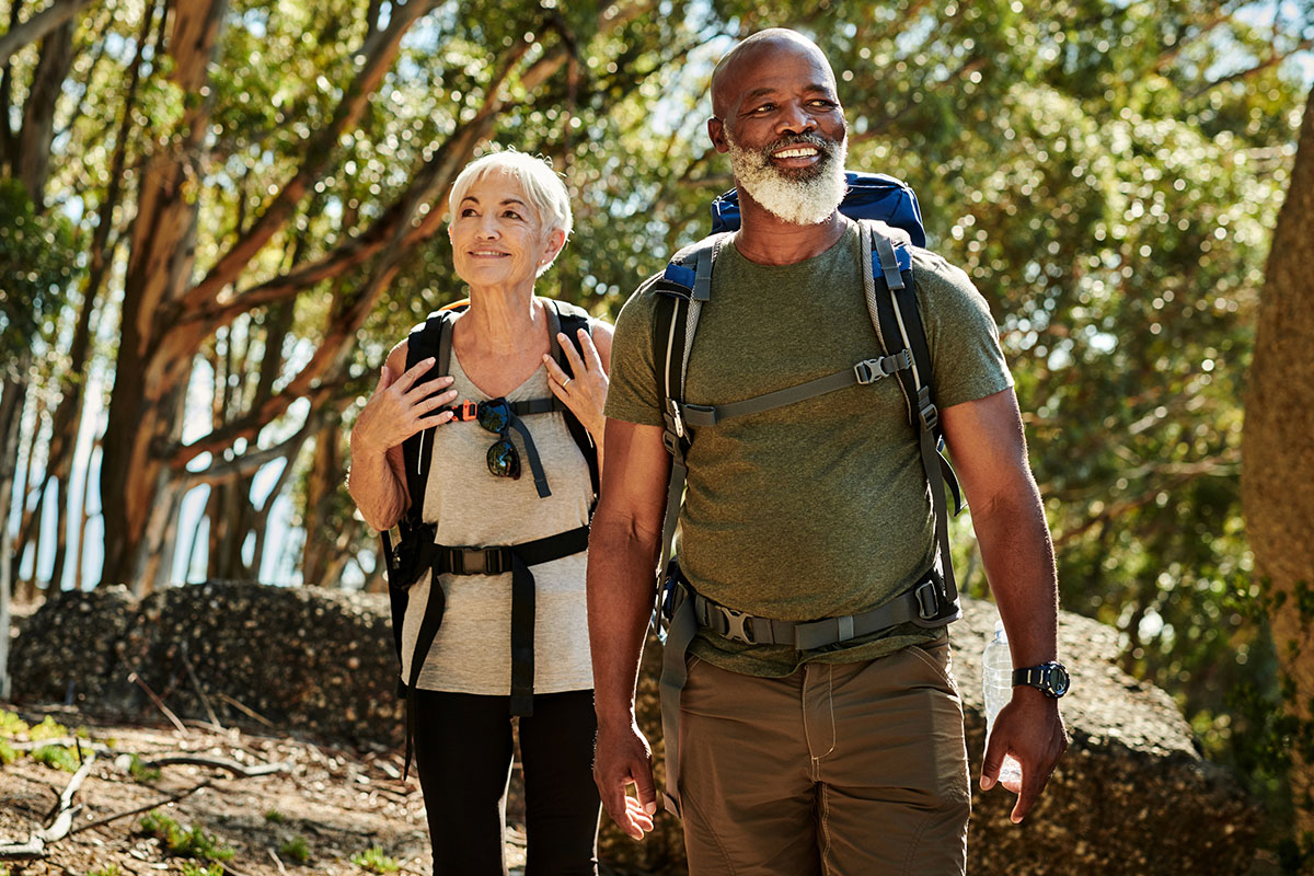 Older couple hiking after peptide therapy