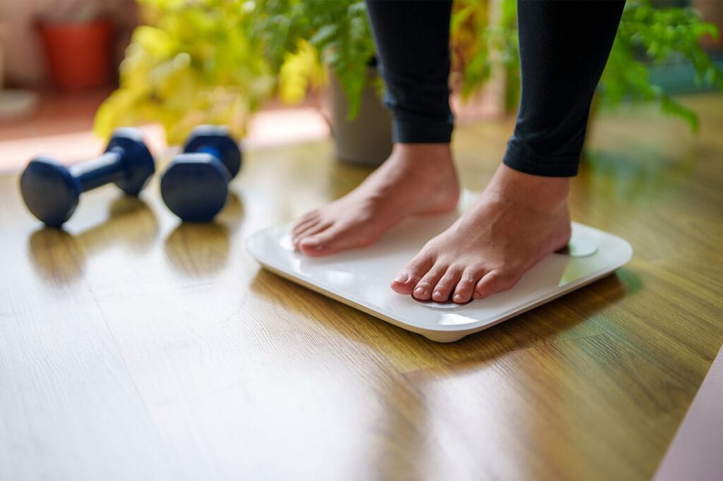 woman weighing herself after starting semaglutide in Port Orange, FL