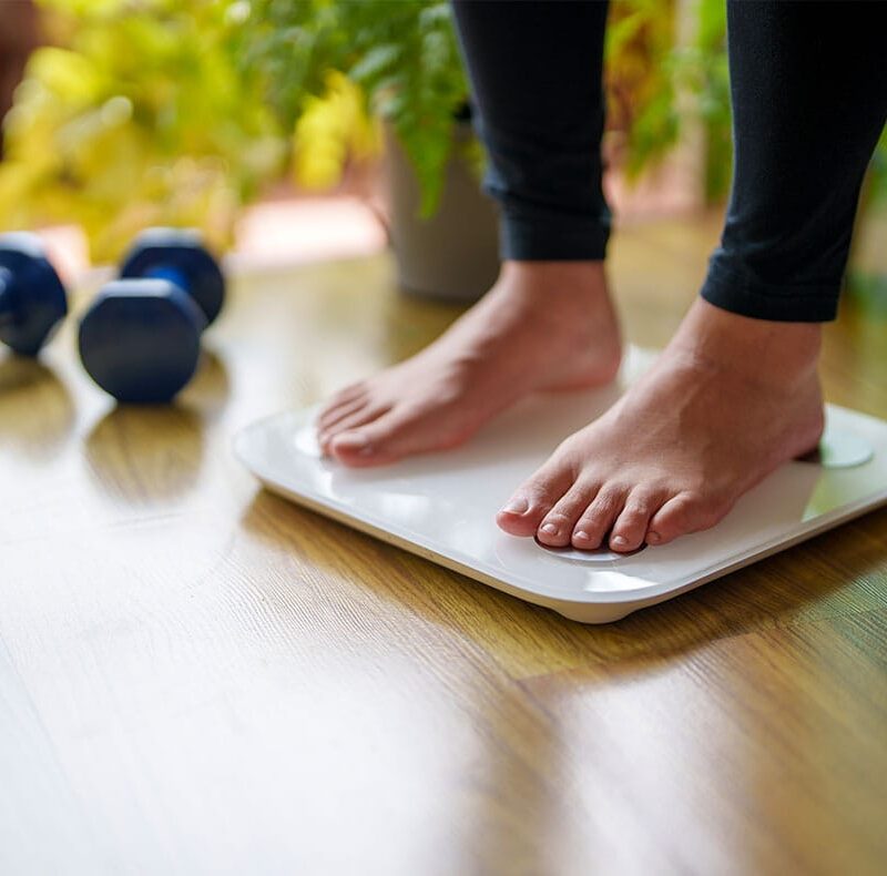 woman weighing herself after starting semaglutide in Port Orange, FL