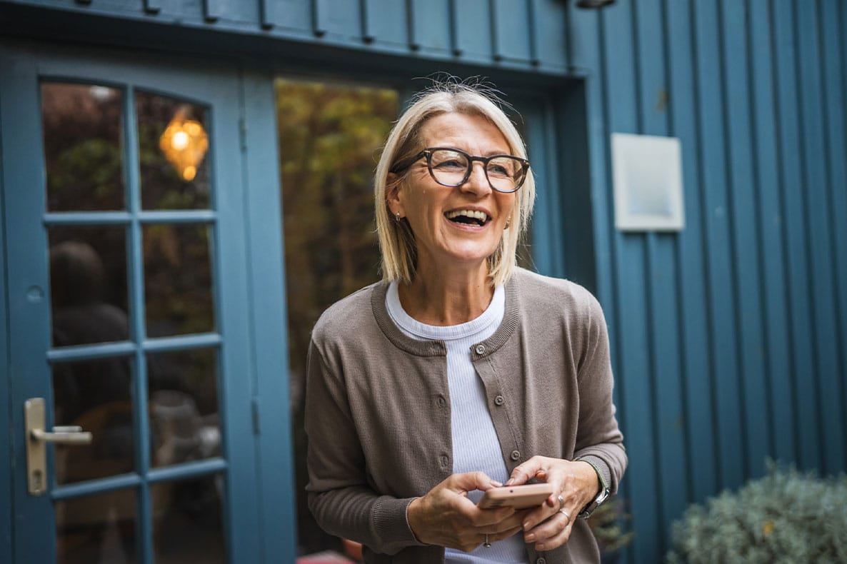 older woman laughing after starting hormone replacement therapy