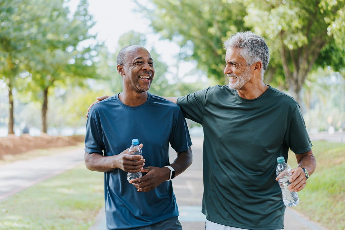 two older men walking outside after taking testosterone pellets