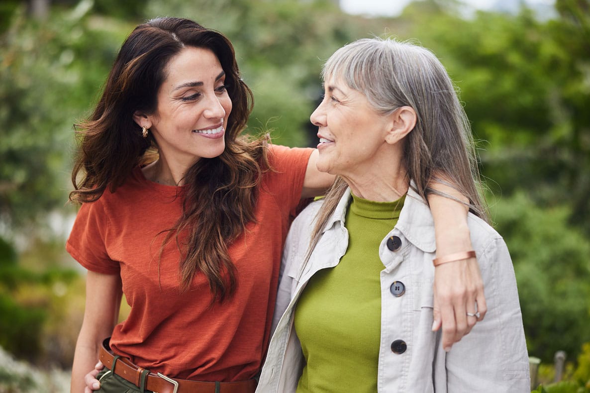 older woman and younger woman walking together after starting hormone therapy