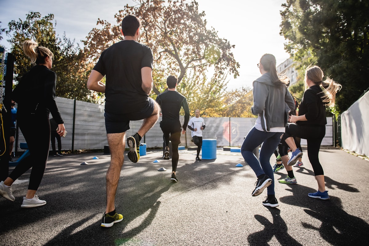 Group fitness class working out together outdoors - Yunique Medical