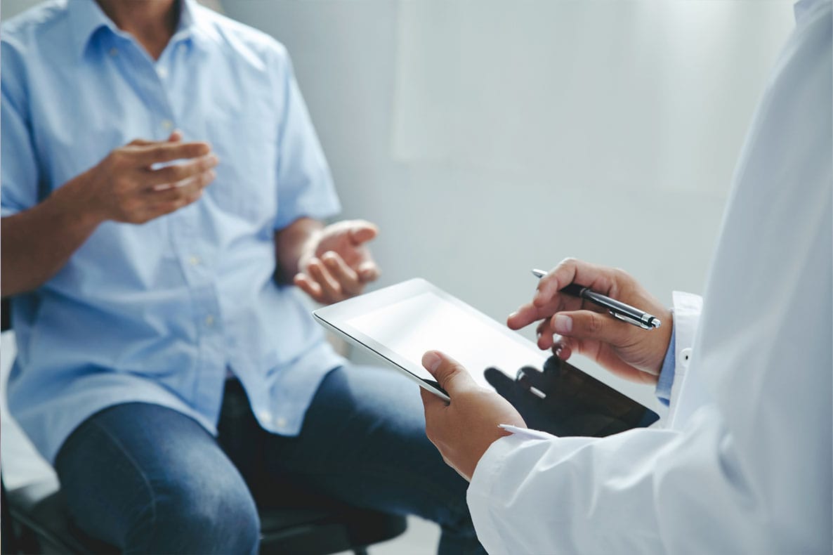 doctor discussing labs with his patient who is doing hrt