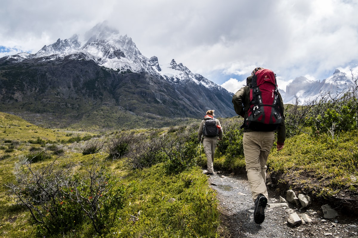 Couple hiking through dramatic mountain scenery - Yunique Medical