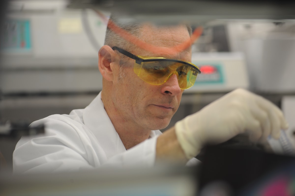 Researcher in safety goggles working at a laboratory bench - Yunique Medical