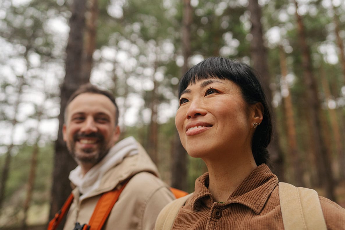 happy couple hiking outside together after starting pellet hormone therapy