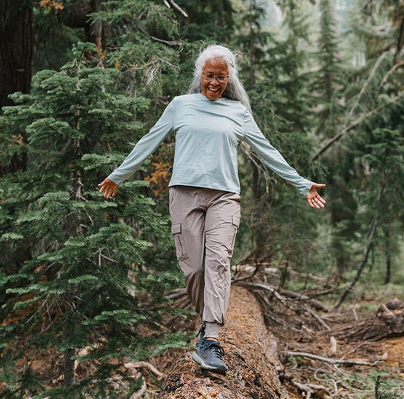 older woman hiking after getting therapeutic plasma exchange