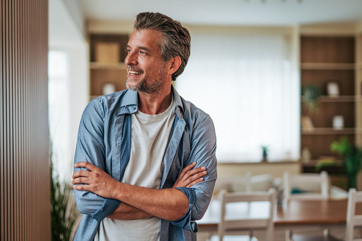 older man smiling after starting hormone replacement therapy