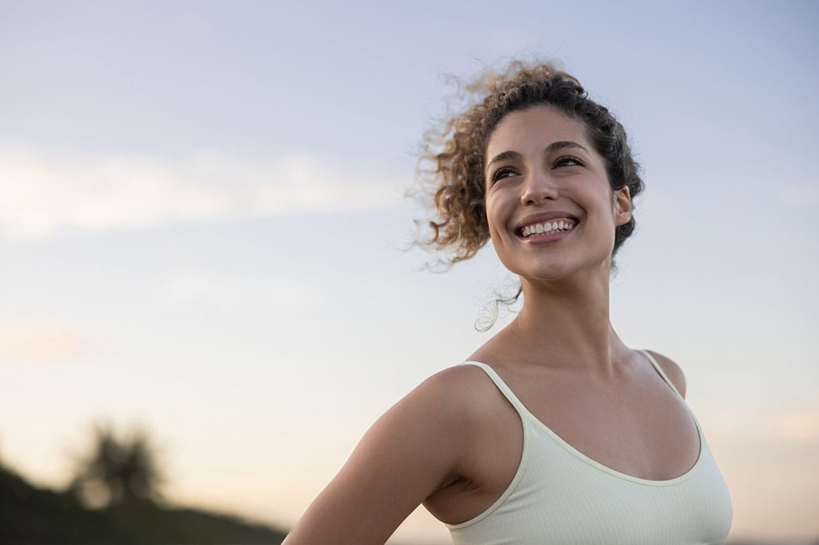 happy woman outside after starting hormone replacement therapy