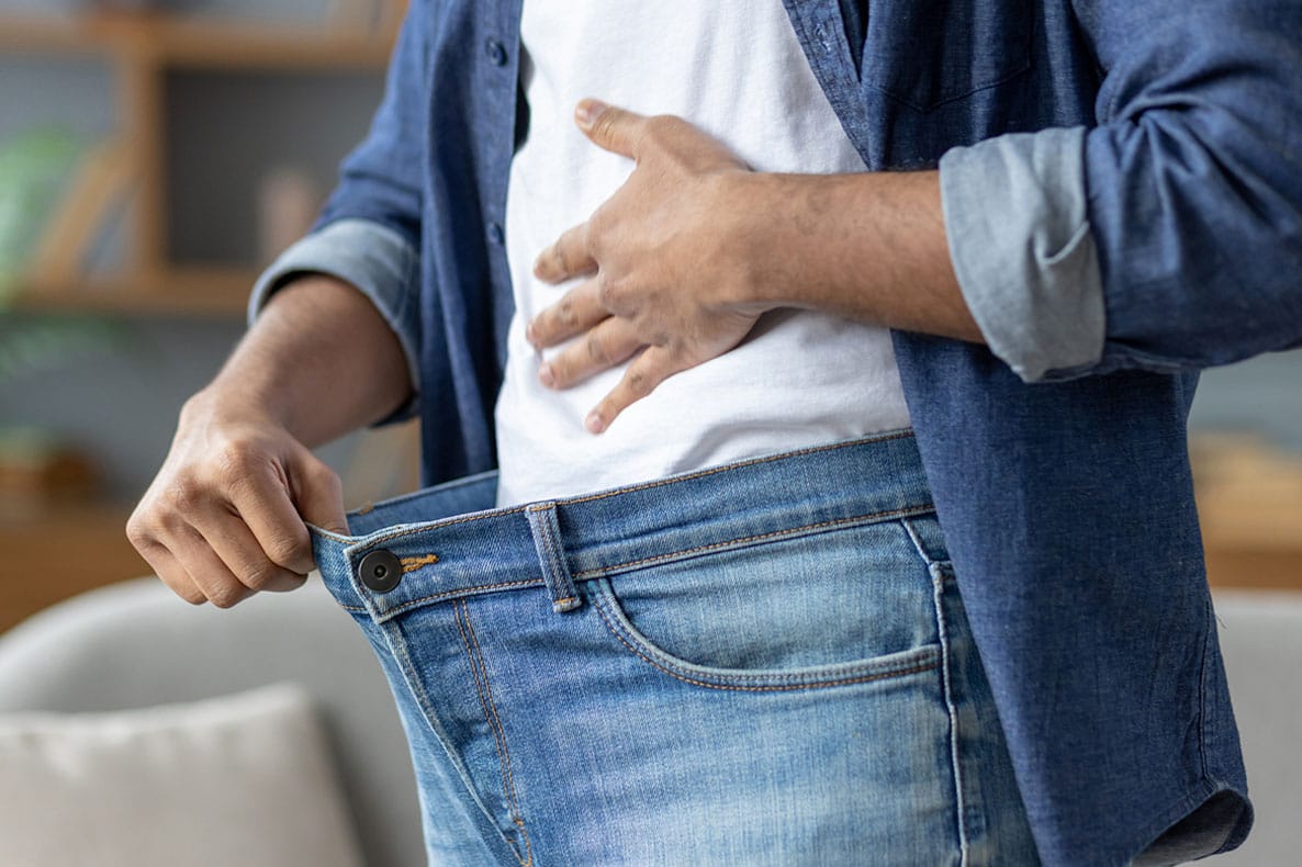 man showing his weight loss after starting semaglutide